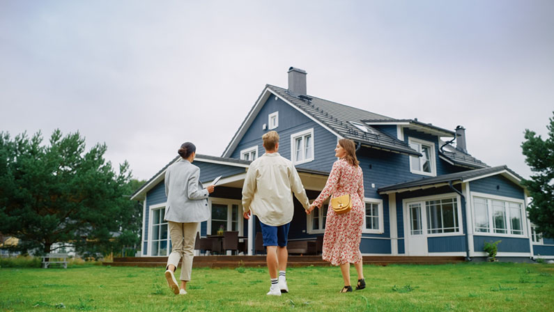 family holding hands on home lawn